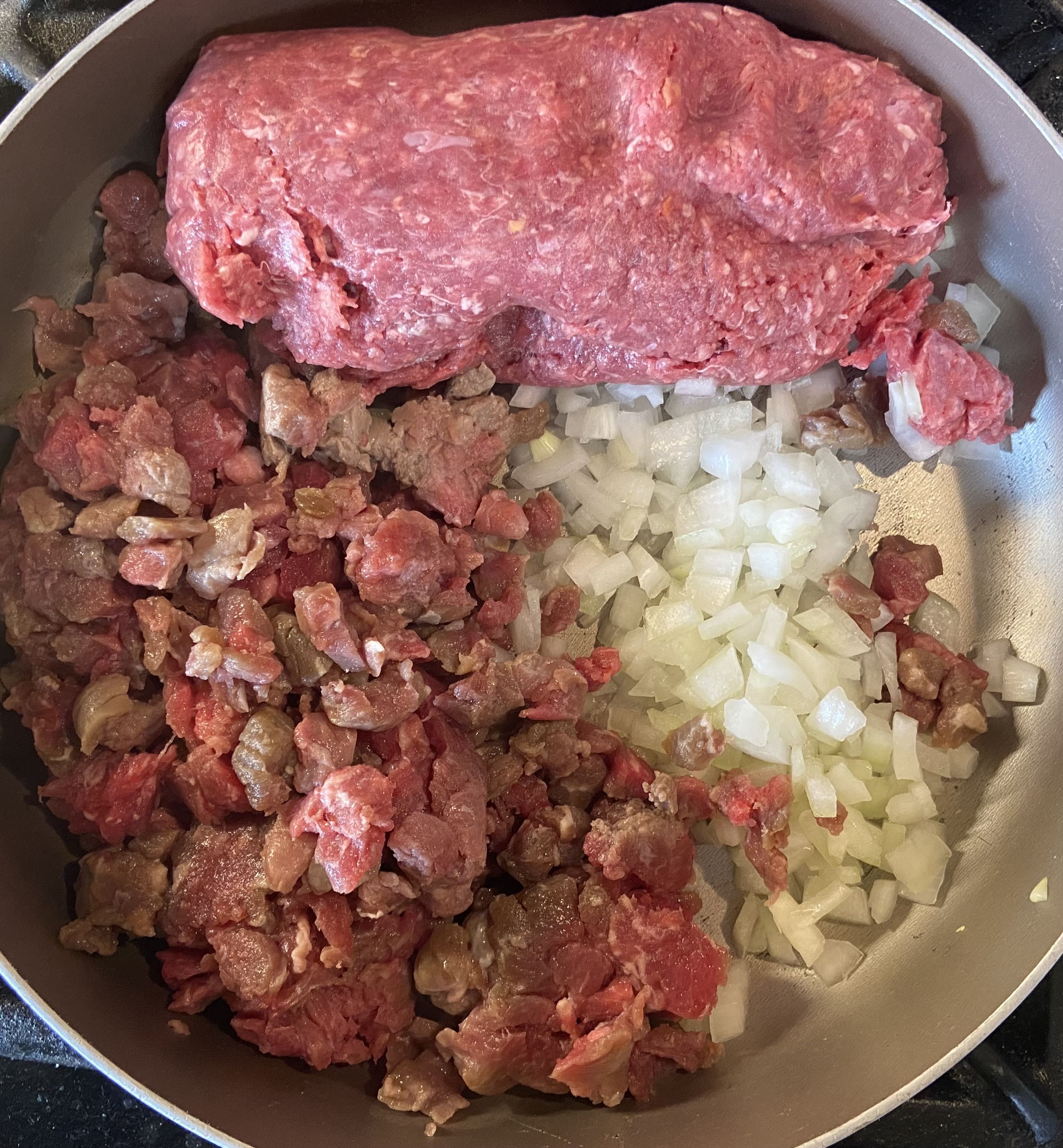 add meats and onion to larger pan